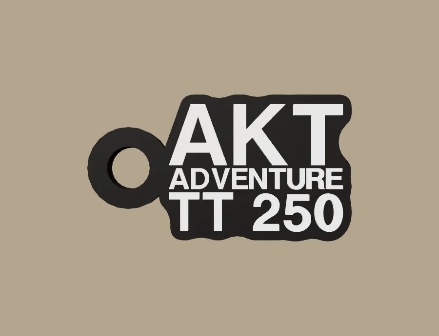 Llavero AKT AKT ADVENTURE TT 250, base negra y texto blanco, vista frontal del modelo 3D